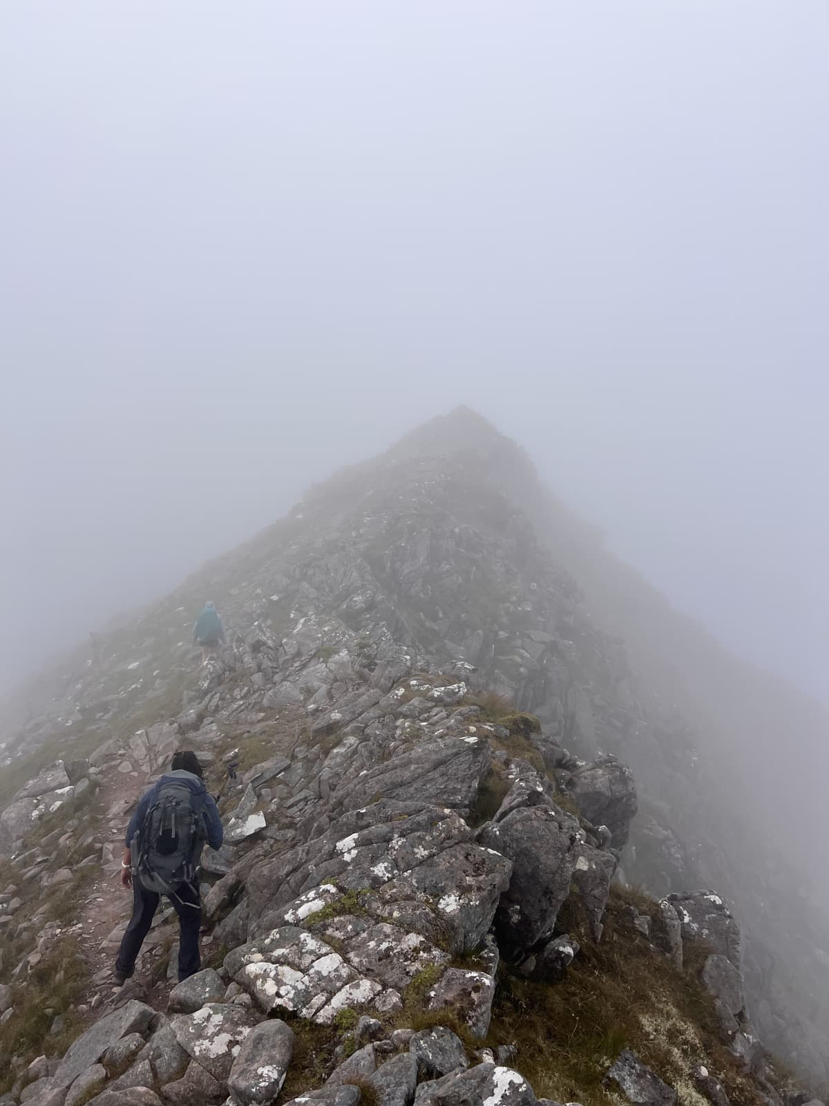 A mountain ridge in Torridon disappearing into mist and low cloud