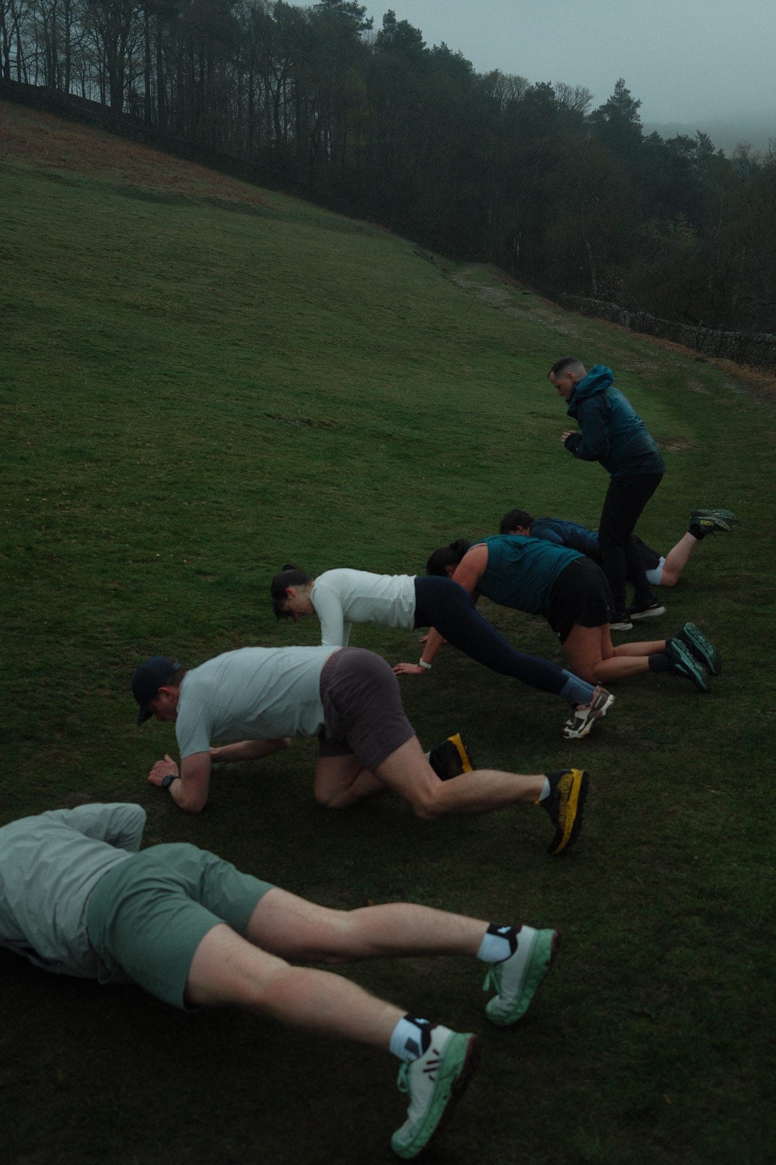 A Jove Club group training on a hillside on a misty morning